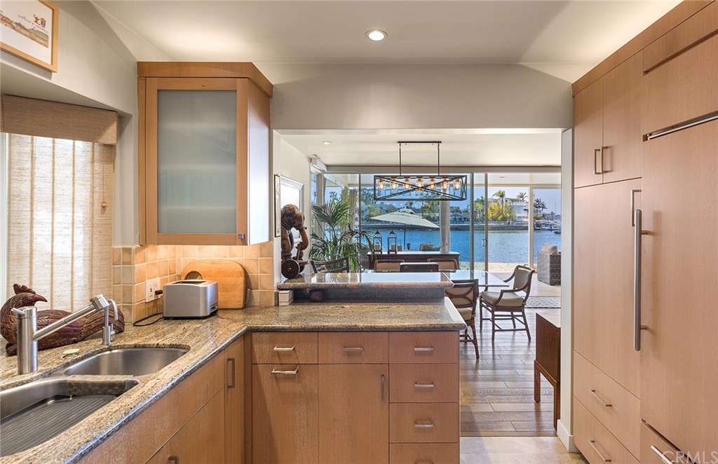 7 Beacon Bay Newport Beach, CA 92660 - Photo 23 of 59 a kitchen with a sink and a refrigerator