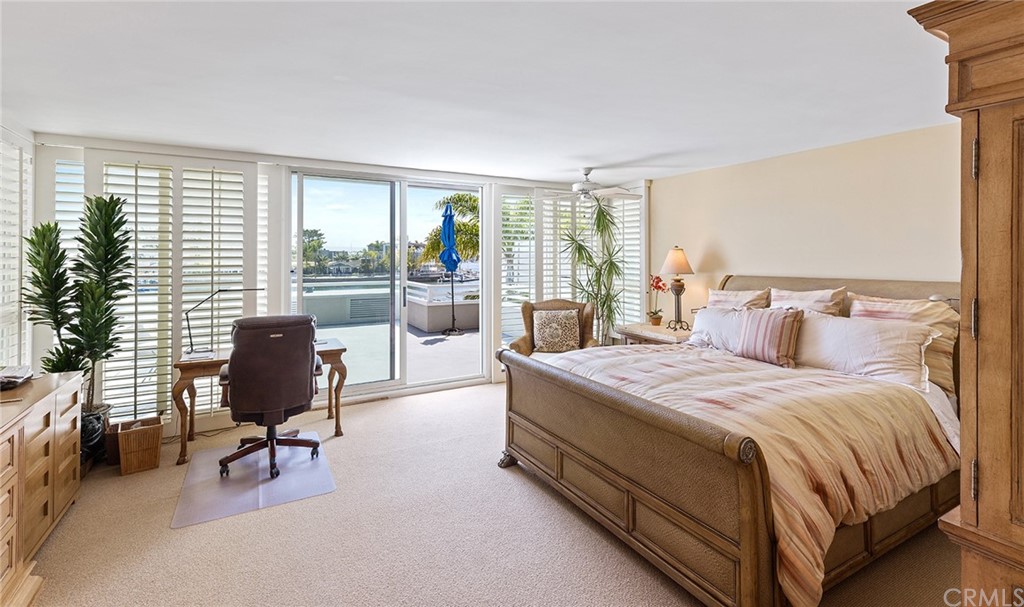 7 Beacon Bay Newport Beach, CA 92660 - Photo 27 of 59 a bedroom with a bed and glass window