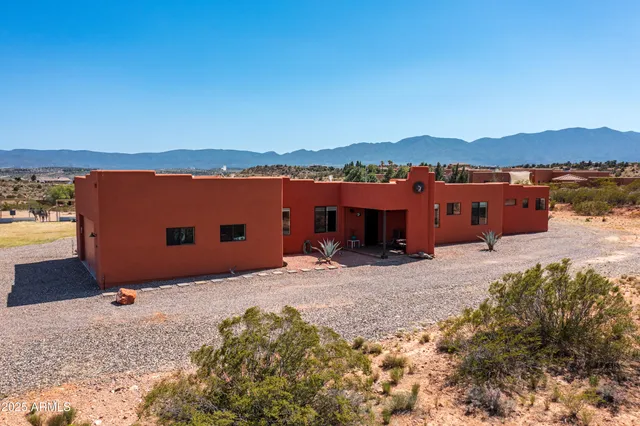 a backyard of a house with table and chairs