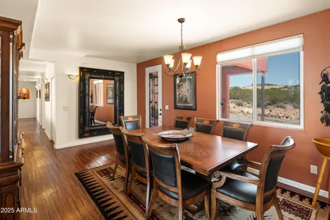 a view of a dining room with furniture wooden floor and chandelier