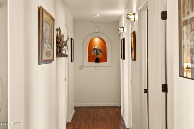 a view of a livingroom with wooden floor and windows