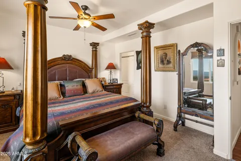 a bedroom with a bed and a chandelier