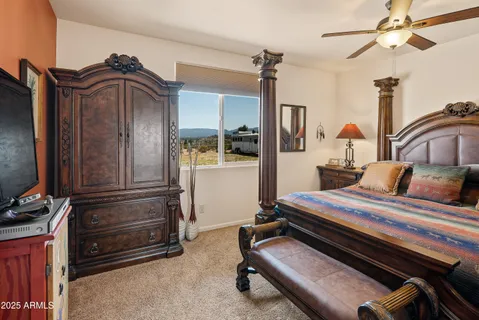 a bedroom with a bed and a ceiling fan
