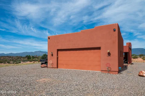 a backyard of a house with barbeque oven and a yard
