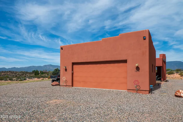 a backyard of a house with barbeque oven and a yard