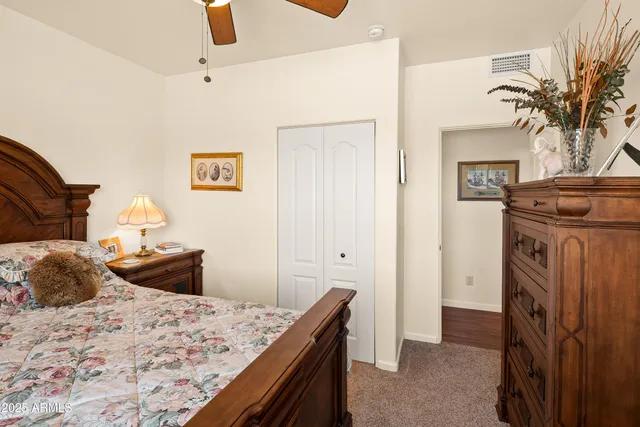 a bedroom with a bed and a dresser