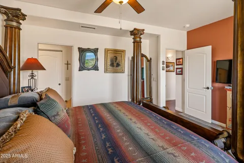 a bedroom with a bed and a chandelier