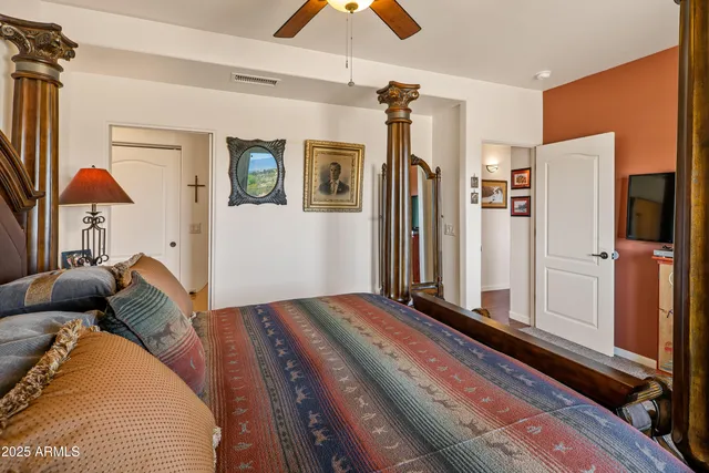 a bedroom with a bed and a chandelier