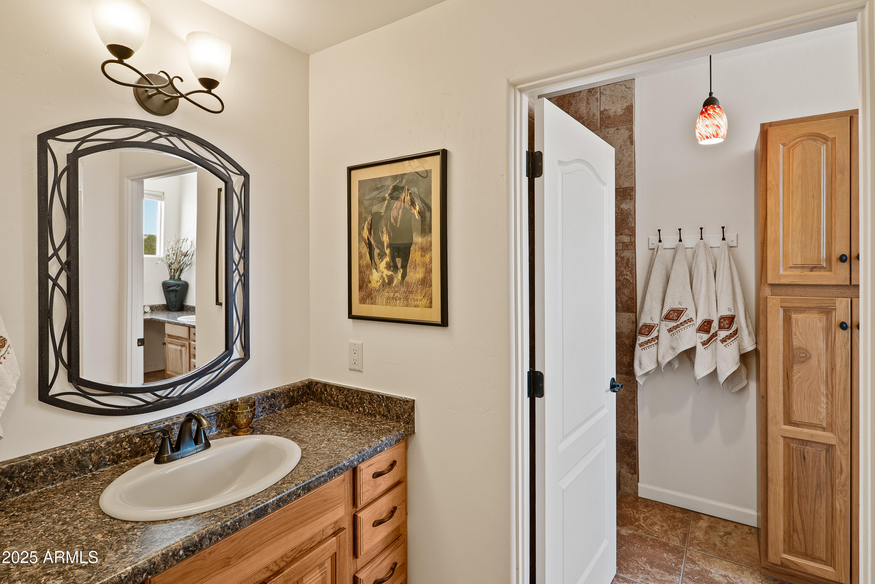 7375 East Sliding Stop Lane Cornville, AZ 86325 - Photo 49 of 53 a bathroom with a granite countertop sink a mirror and shower view