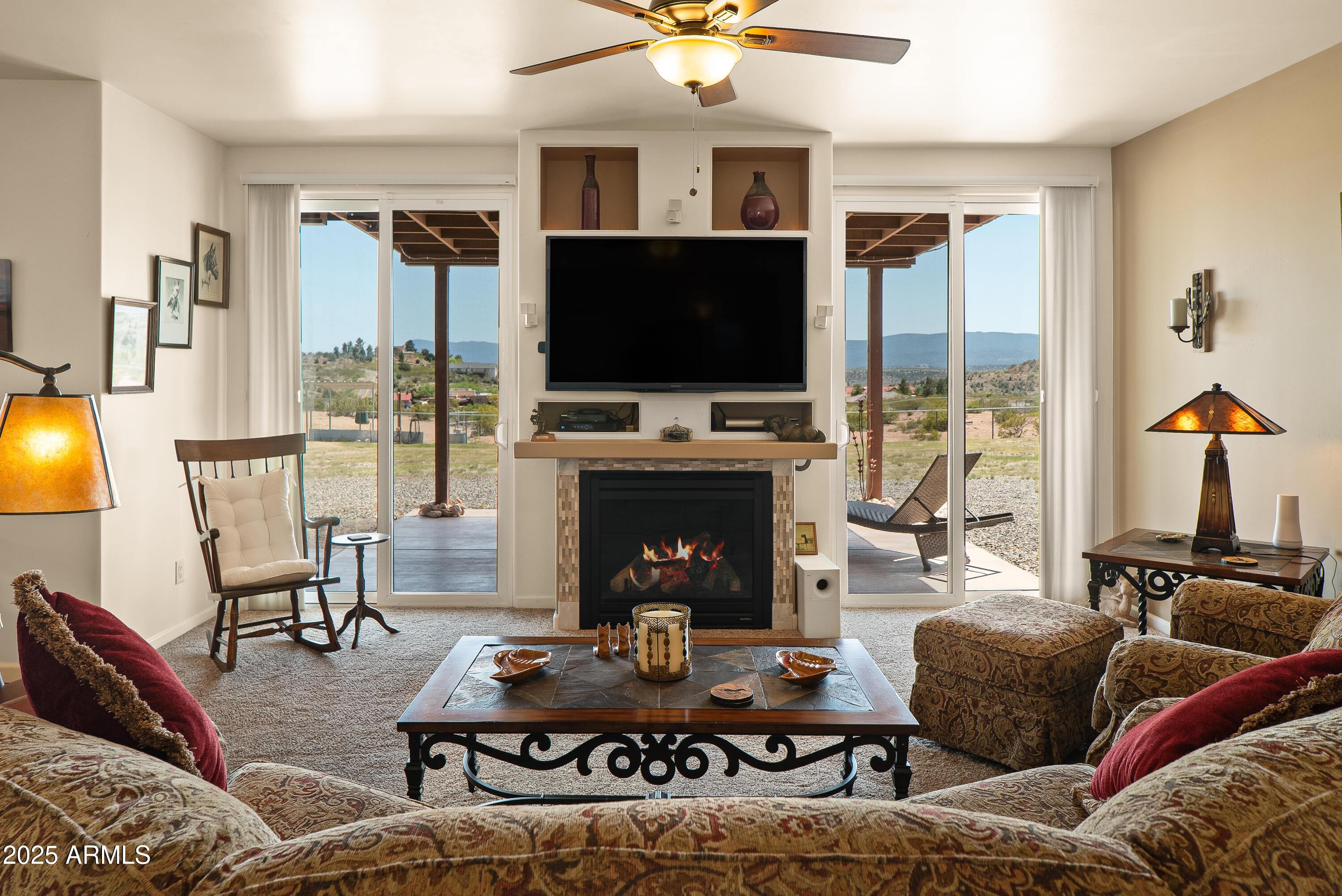 7375 East Sliding Stop Lane Cornville, AZ 86325 - Photo 9 of 53 a living room with furniture a flat screen tv and a fireplace