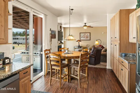 a view of a dining room with furniture wooden floor and chandelier
