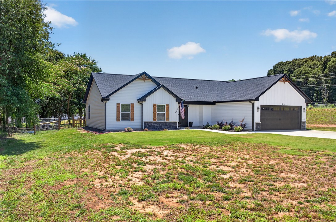 106 Bolt Road Townville, SC 29689 - Photo 32 of 33 White siding with dark trim creates a modern aesthetic for this charming single-story home.