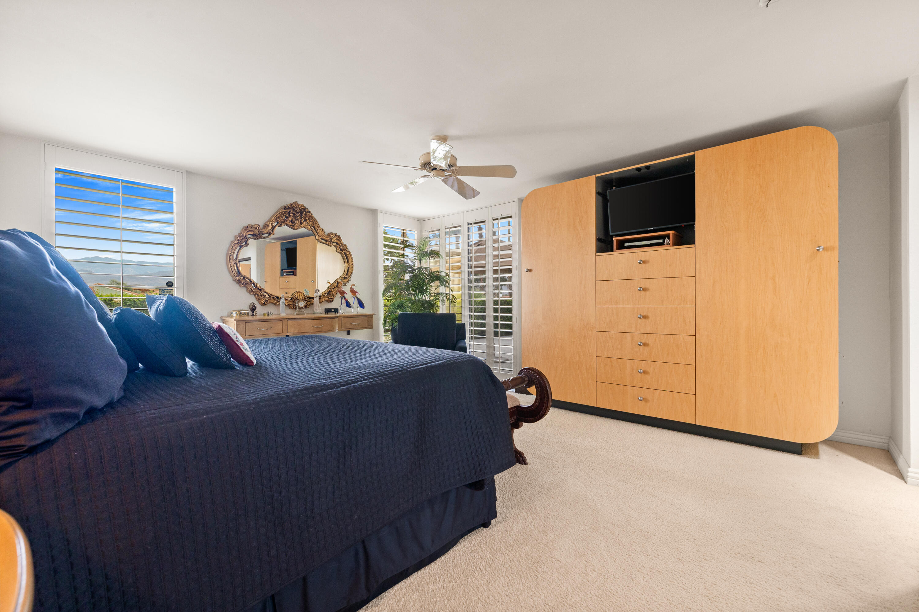 72419 Rodeo Way Rancho Mirage, CA 92270 - Photo 22 of 48 a bedroom with a bed dresser and a flat tv screen