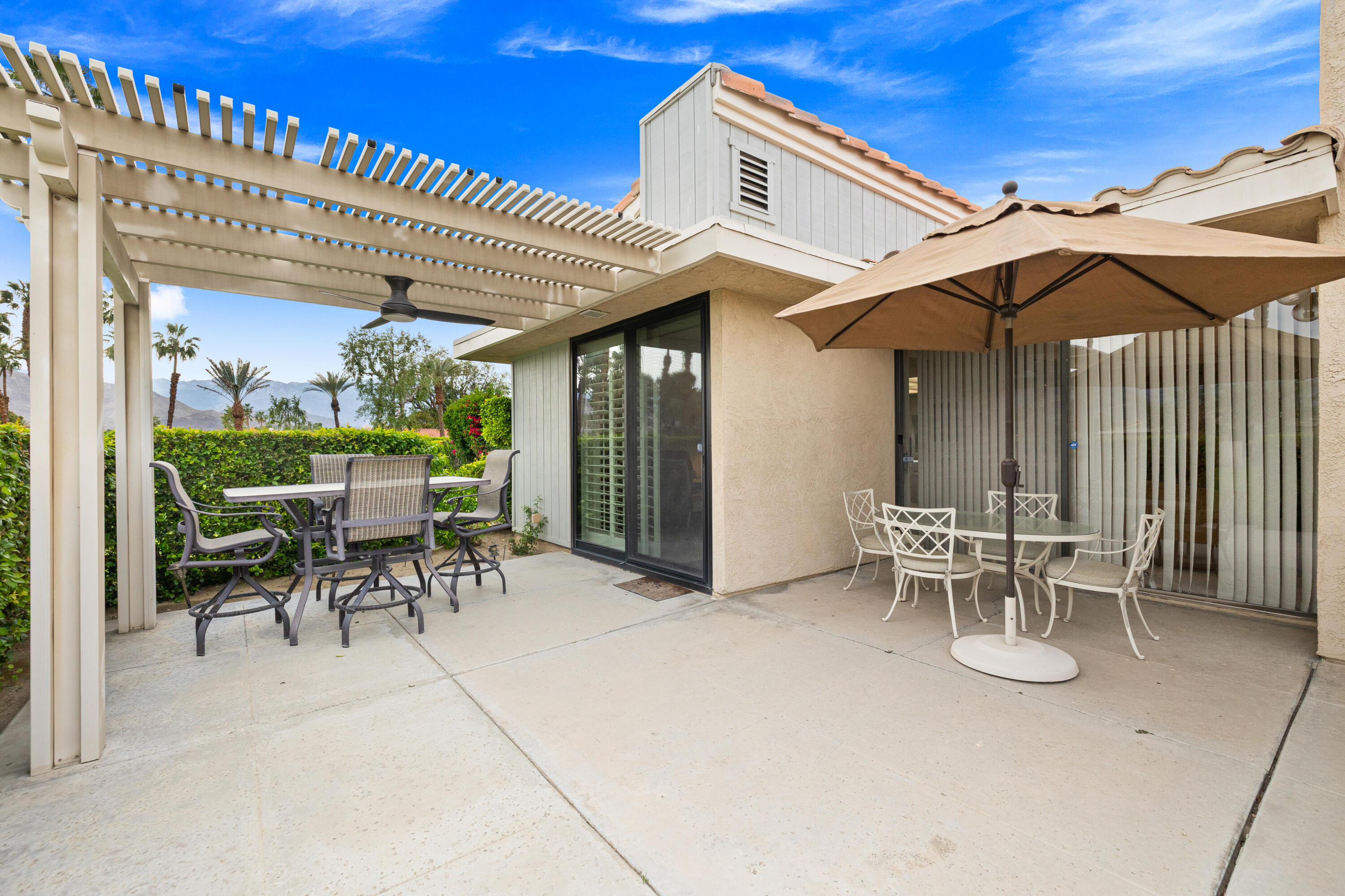72419 Rodeo Way Rancho Mirage, CA 92270 - Photo 31 of 48 a patio with a table and chairs and potted plants