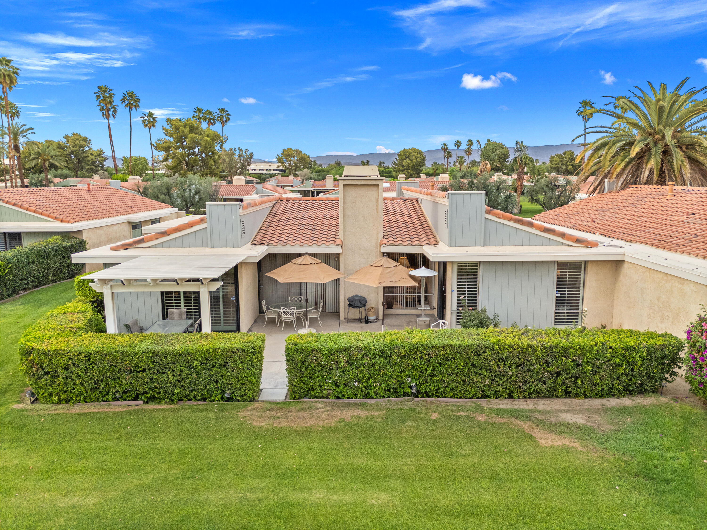 72419 Rodeo Way Rancho Mirage, CA 92270 - Photo 34 of 48 a front view of a house with a garden