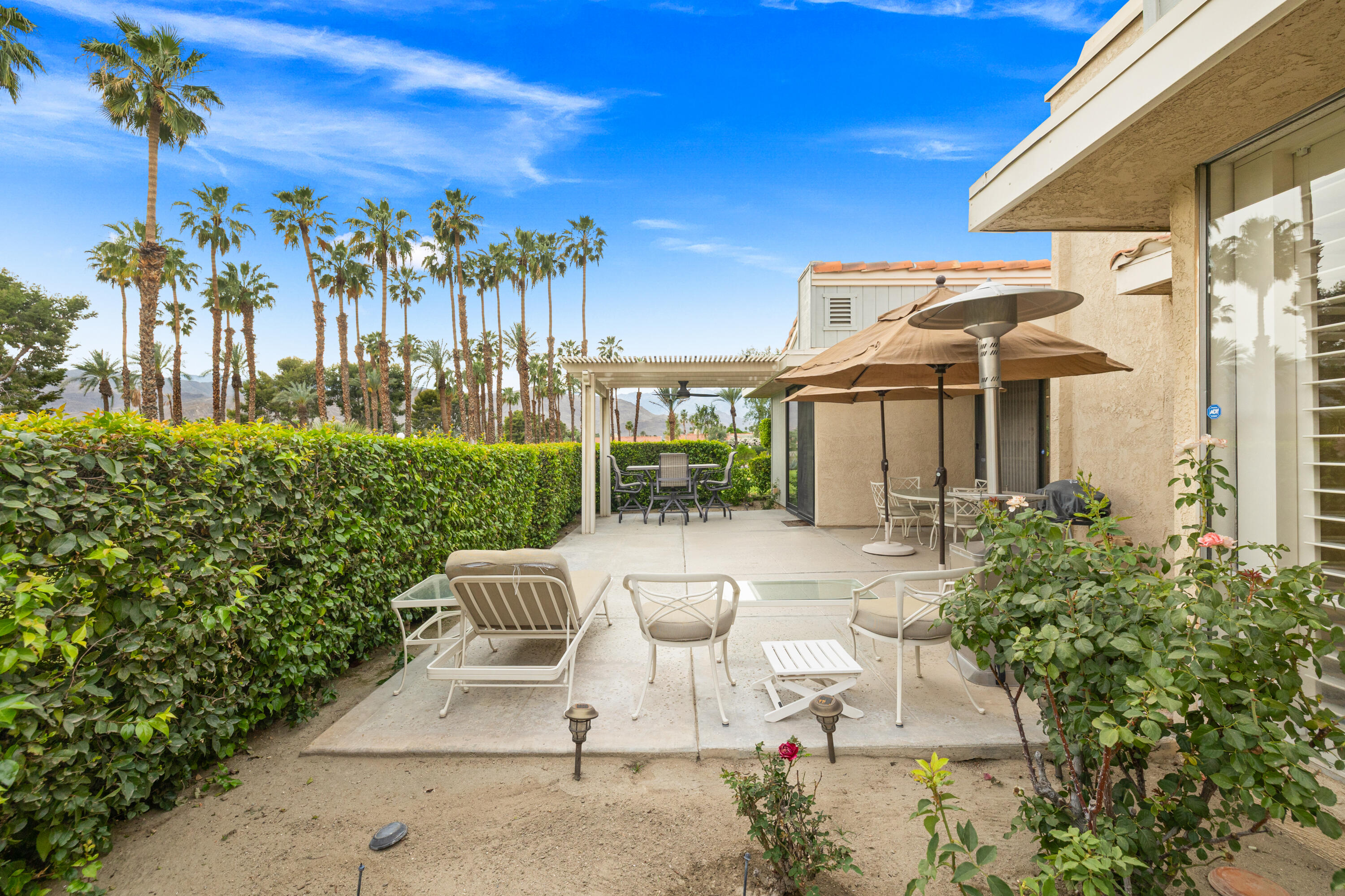 72419 Rodeo Way Rancho Mirage, CA 92270 - Photo 37 of 48 a view of a patio with couches table and chairs and potted plants