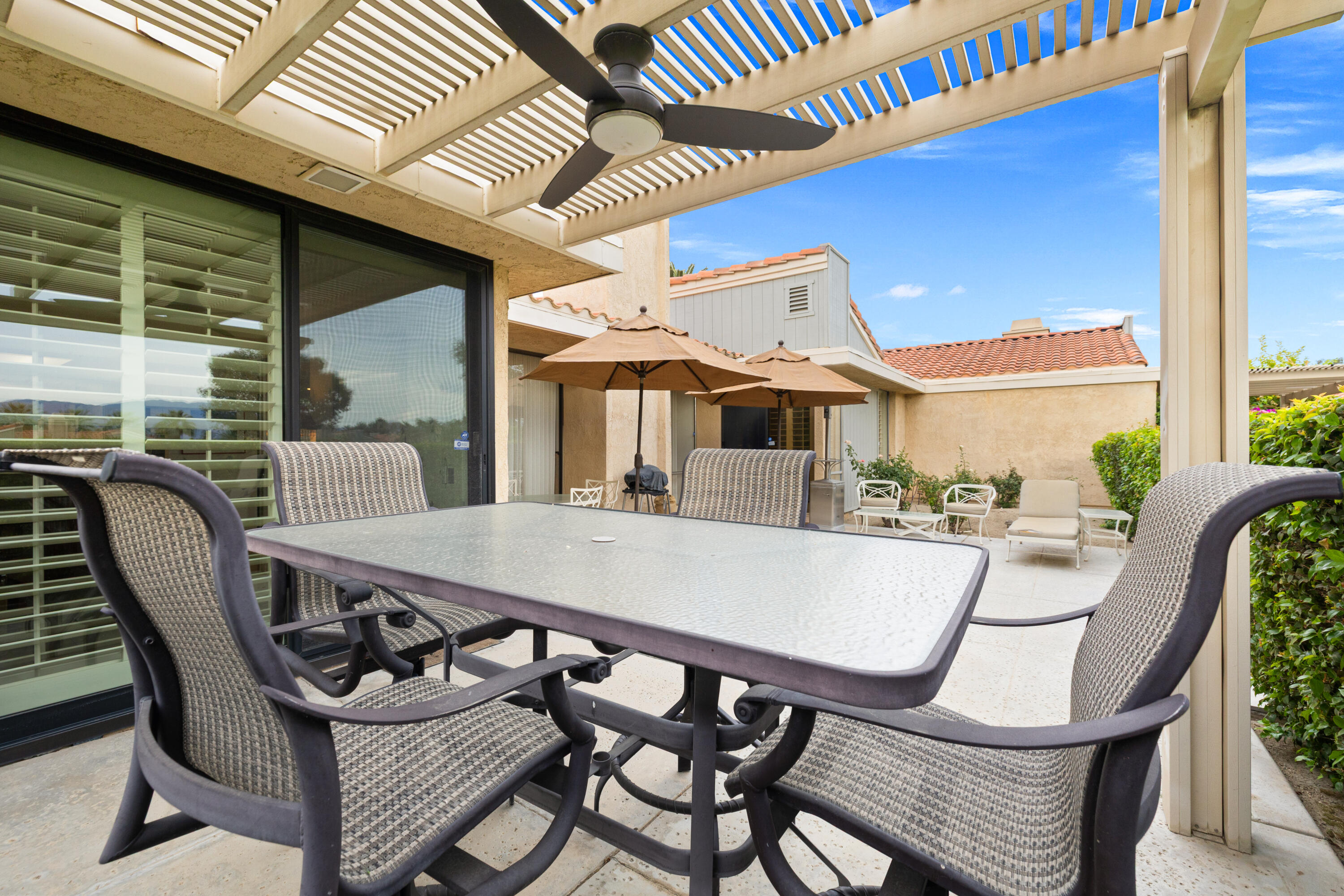72419 Rodeo Way Rancho Mirage, CA 92270 - Photo 41 of 48 a view of a patio with table and chairs