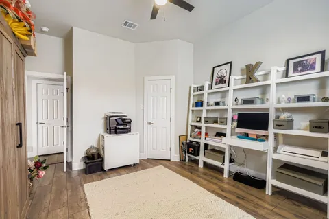 a view of a bedroom with furniture and closet