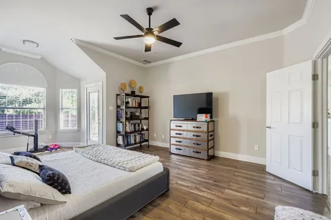 a bedroom with a bed and flat screen tv