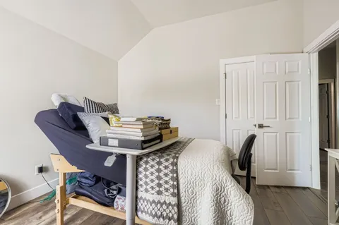 a view of a workspace with furniture and wooden floor