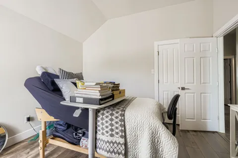 a bedroom with a bed and a chandelier