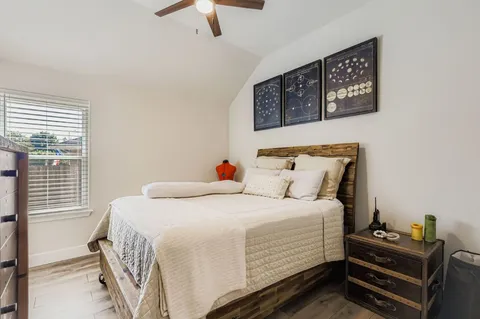 a bedroom with a bed and a chandelier