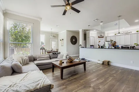 a living room with furniture and large windows