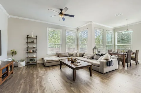 a living room with furniture and large windows