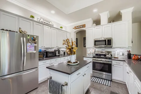 a kitchen with a sink appliances and cabinets