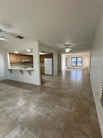 a view of a hallway with wooden floor and fireplace