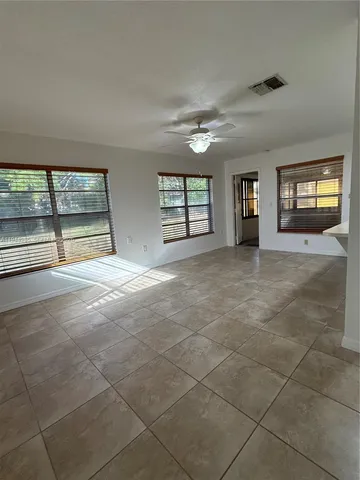 a view of an empty room with windows