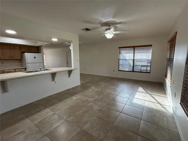 a view of a kitchen with a sink and cabinets