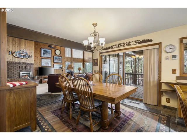 a view of a dining room with furniture wooden floor and chandelier