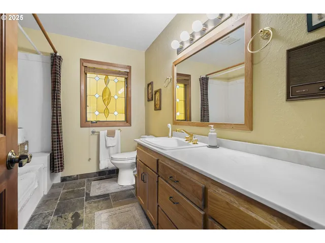 a bathroom with a sink a mirror and a toilet