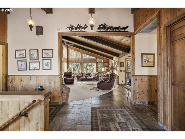 a living room with furniture a chandelier and a window