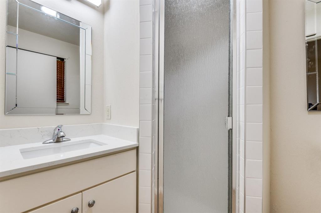2413 Cheyenne Street Irving, TX 75062 - Photo 13 of 19 a bathroom with a sink and a mirror