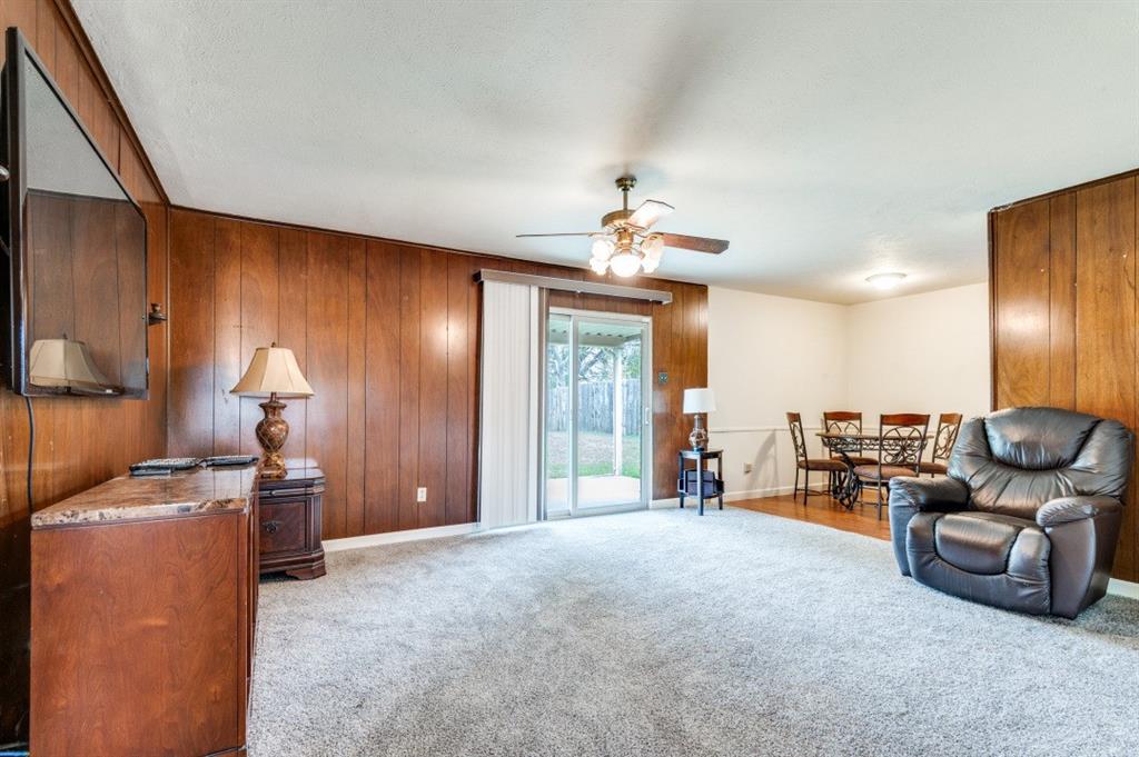 2413 Cheyenne Street Irving, TX 75062 - Photo 7 of 19 a living room with furniture and a chandelier
