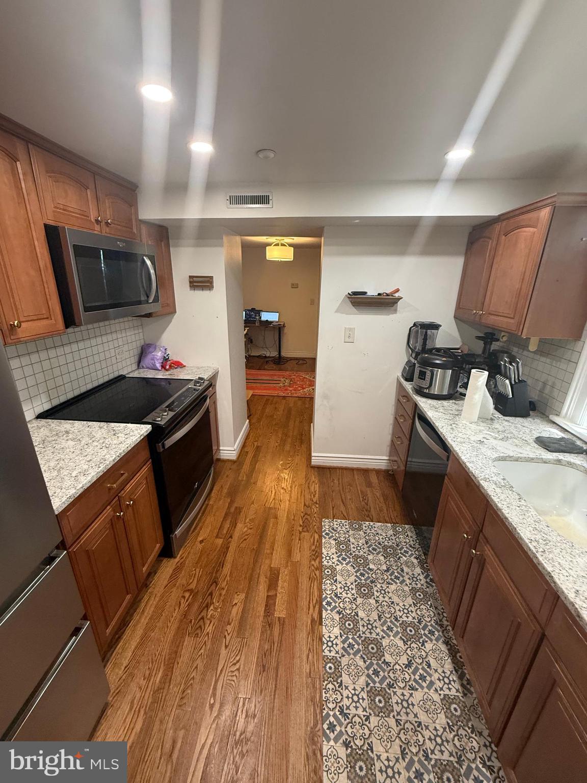 37 South Prospect Street, Unit 101 Hagerstown, MD 21740 - Photo 14 of 51 a kitchen with stainless steel appliances granite countertop a sink stove and refrigerator