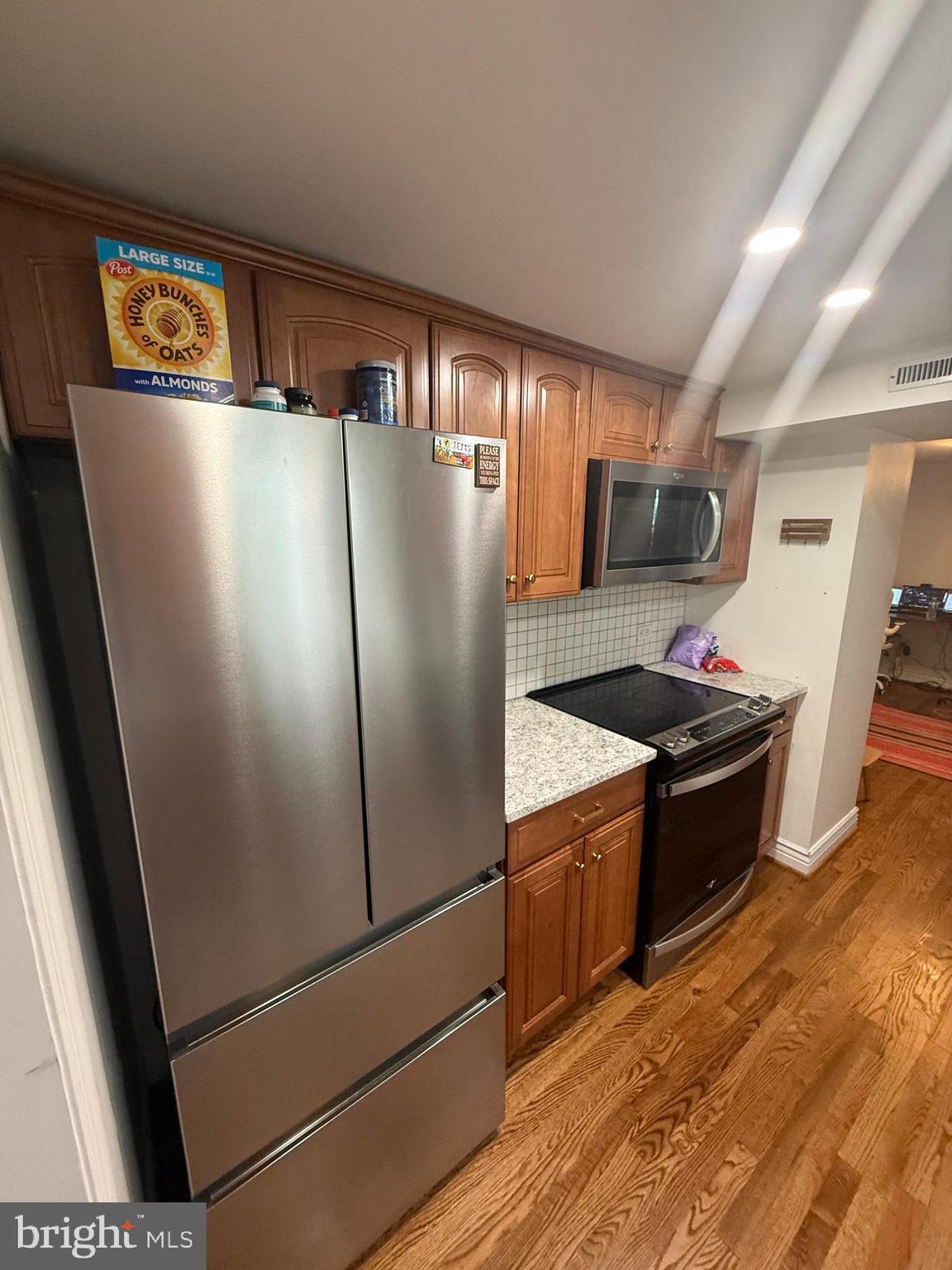 37 South Prospect Street, Unit 101 Hagerstown, MD 21740 - Photo 20 of 51 a kitchen with stainless steel appliances a refrigerator a stove a sink a washer dryer and a cabinets