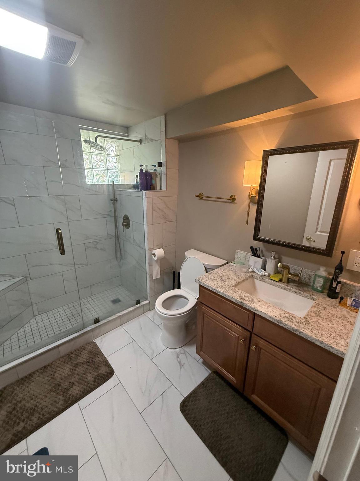 37 South Prospect Street, Unit 101 Hagerstown, MD 21740 - Photo 24 of 51 a bathroom with a double vanity sink toilet and shower