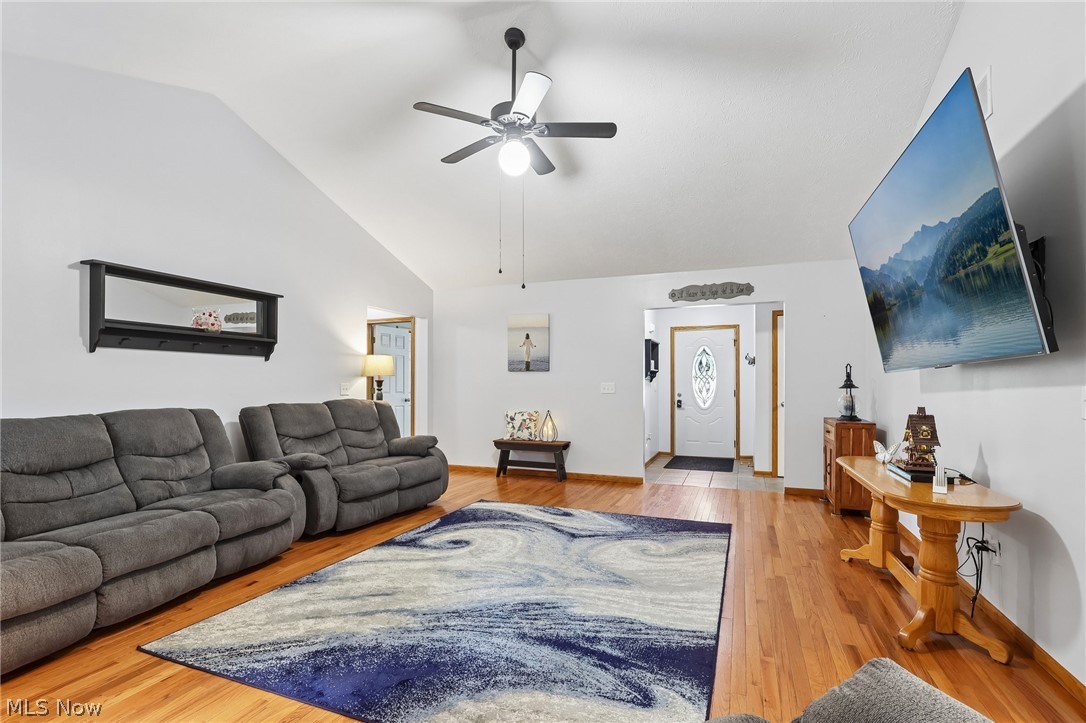 3213 Bates Road Madison, OH 44057 - Photo 6 of 45 Living area with vaulted ceiling and wood-finish flooring