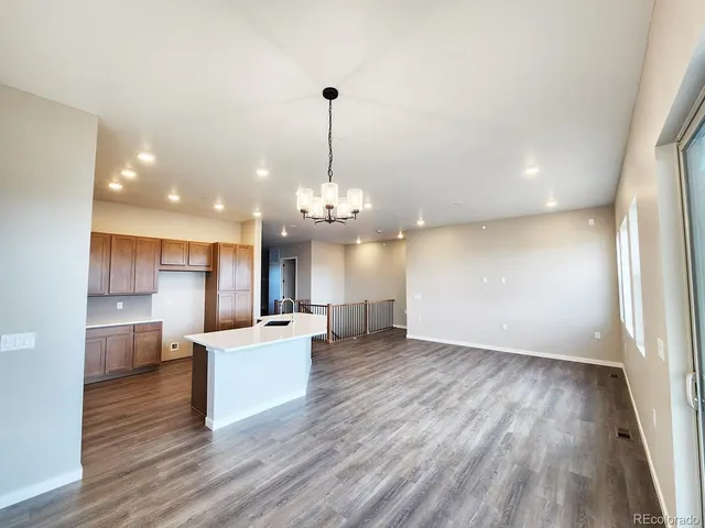 a view of a kitchen with stove and wooden floor