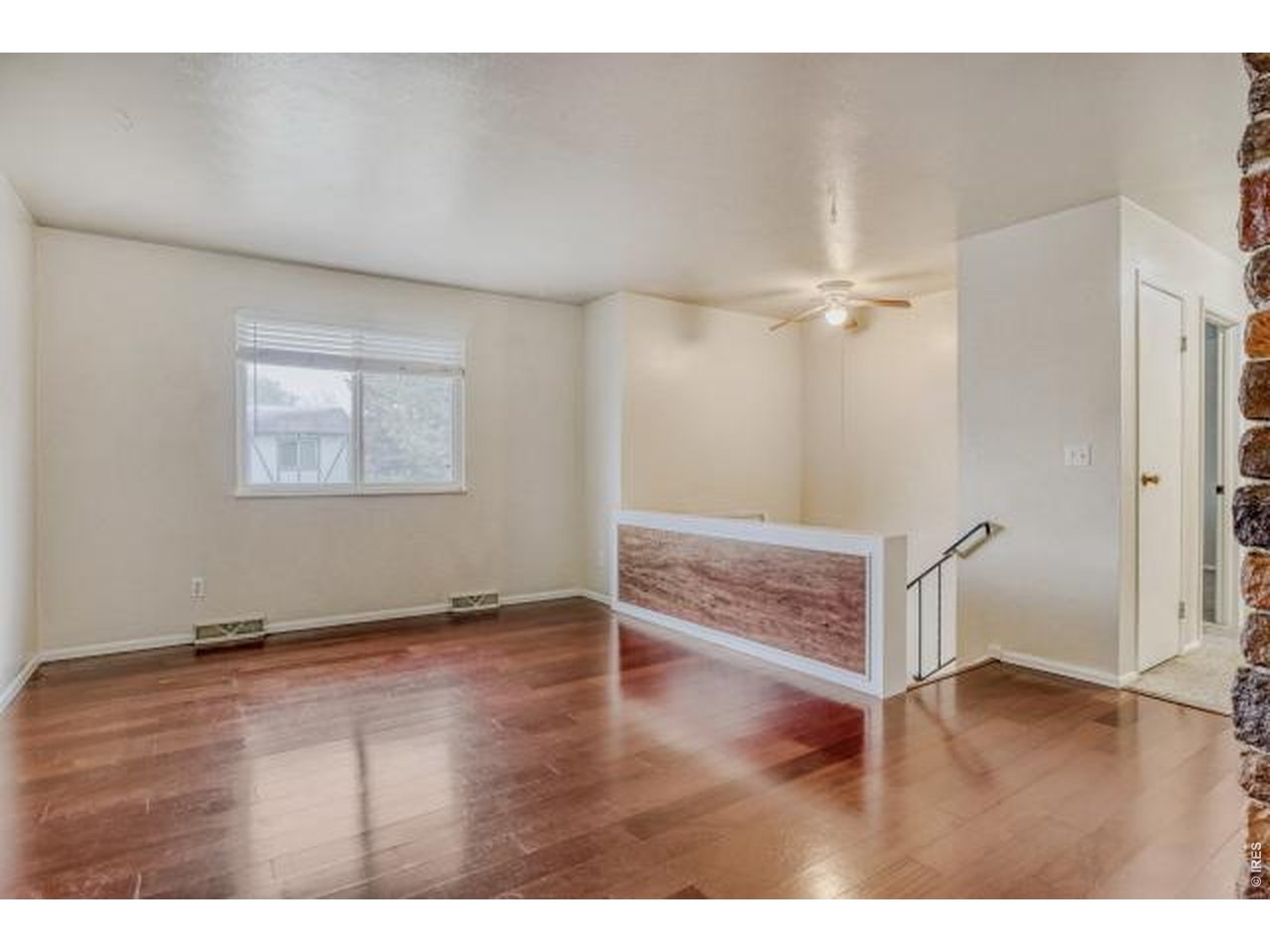 10748 Routt Street Broomfield, CO 80021 - Photo 10 of 30 a view of an empty room with wooden floor