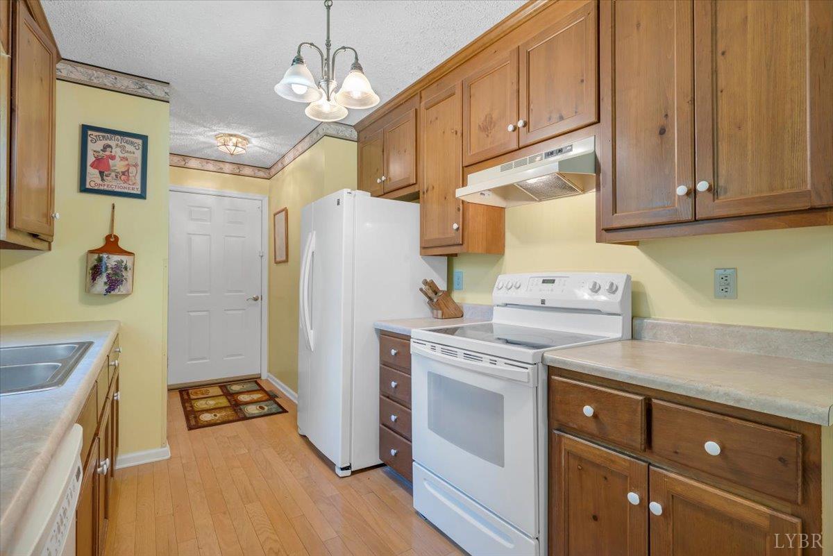 1124 Homeplace Road Bedford, VA 24523 - Photo 13 of 47 a kitchen with a refrigerator a stove top oven and cabinets