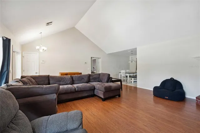 a living room with furniture flat screen tv and wooden floor