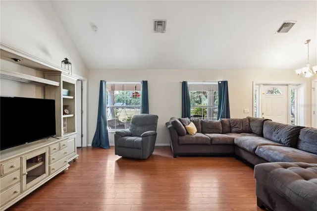 a living room with furniture flat screen tv and a fireplace