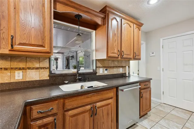 a dining room with wooden floor a chandelier a wooden table and chairs
