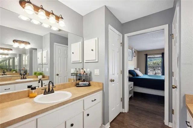 a bathroom with a sink vanity mirror and toilet