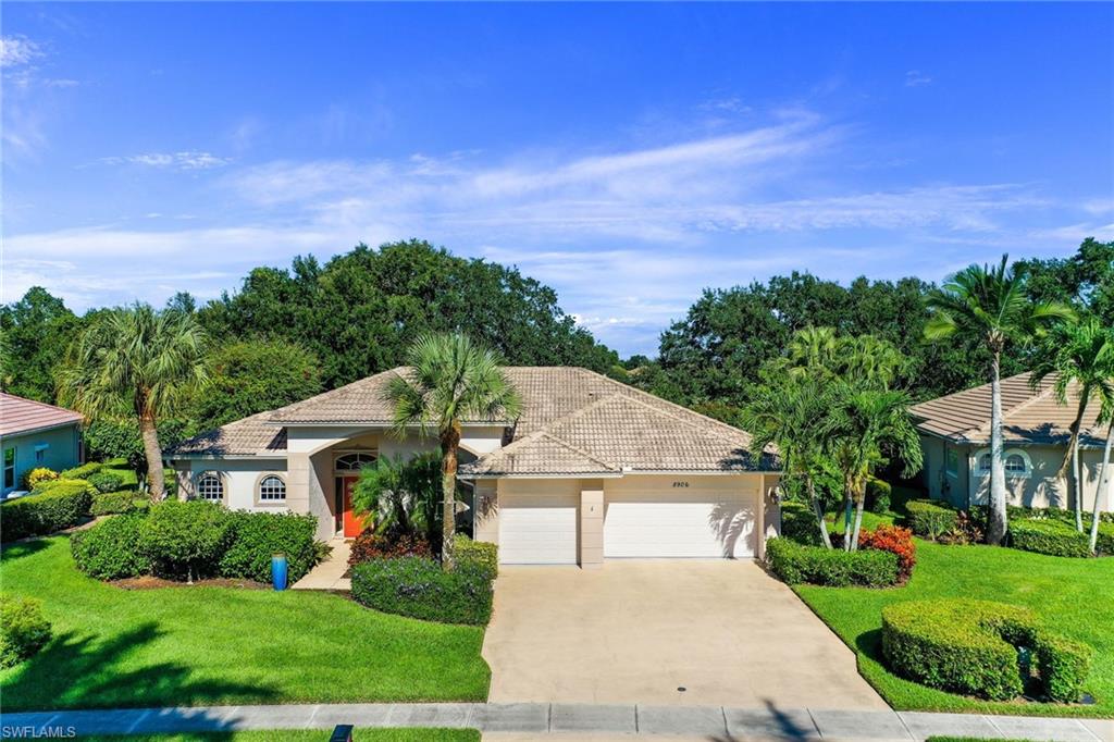 8906 Lely Island Circle Naples, FL 34113 - Photo 1 of 34 a front view of a house with a yard