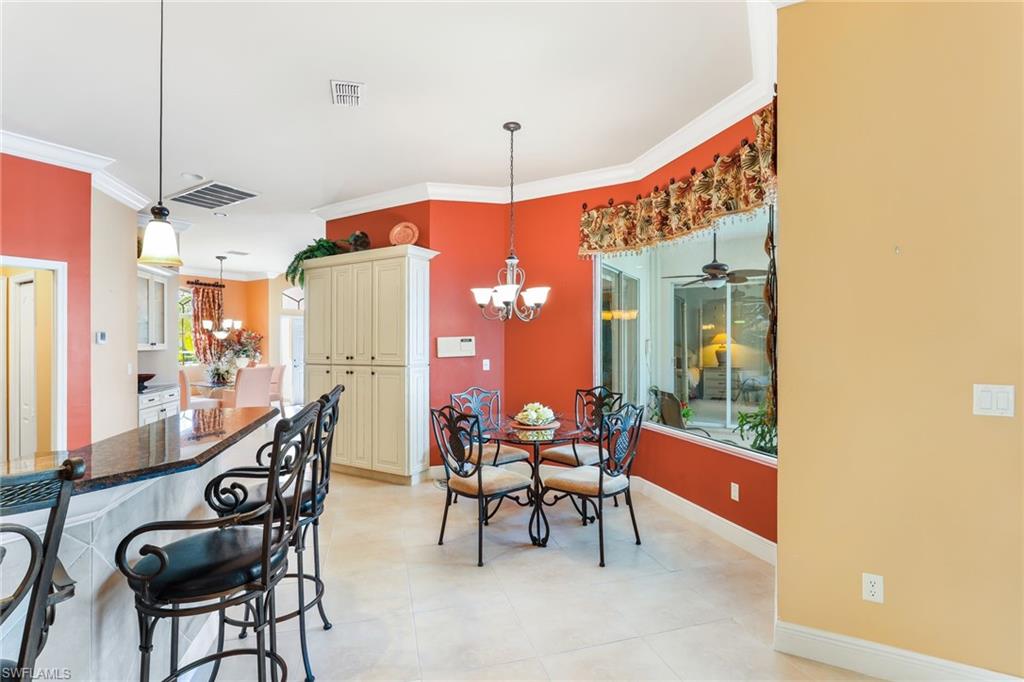 8906 Lely Island Circle Naples, FL 34113 - Photo 15 of 34 a view of a dining room with furniture window and outside view